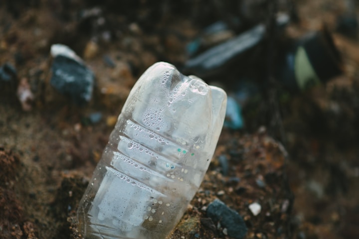 Plastic waste with residue in soil — partial breakdown