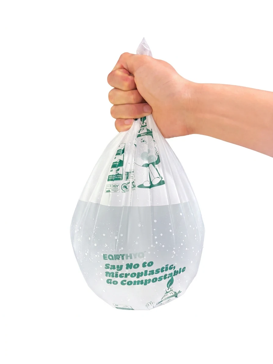 Hand holding a filled Earthya compostable waste bag