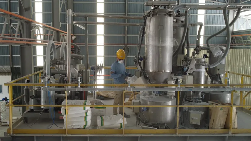 Manufacturing team member in PPE working at the production line